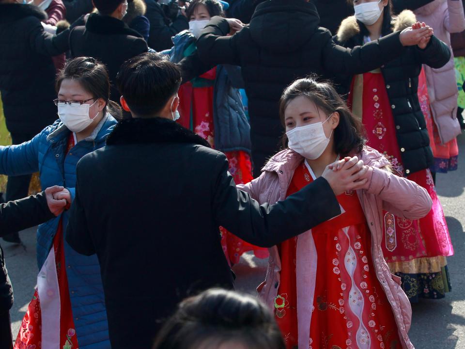 Students dance during the celebrations of the 74th founding anniversary of Korean People's Army in the plaza of the Pyongyang Indoor Stadium in Pyongyang, North Korea, Tuesday, Feb. 8, 2022.