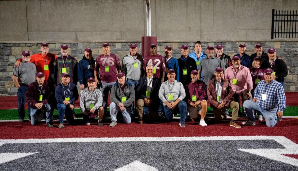 Players from the 1973 State College football team pose for a photo to celebrate the 50th anniversary of winning the PIAA state title.