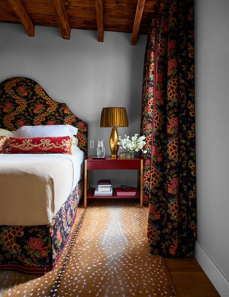 A Cowtan & Tout fabric dresses the headboard, valance, and curtains in the Marroquins’ bedroom; Design Frères nightstand, Stark rug.