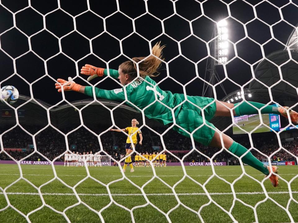 USWNT goalkeeper Alyssa Naeher dives in an attempt to save a penalty kick against Sweden at the 2023 World Cup.