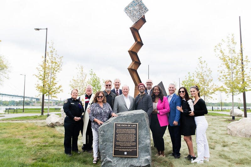 Mayor Mike Duggan, the designers of the sculpture brothers Israel and Erik Nordin, funders of the sculpture the Adamo Group and city officials in front of Riverside Park's newest sculpture.