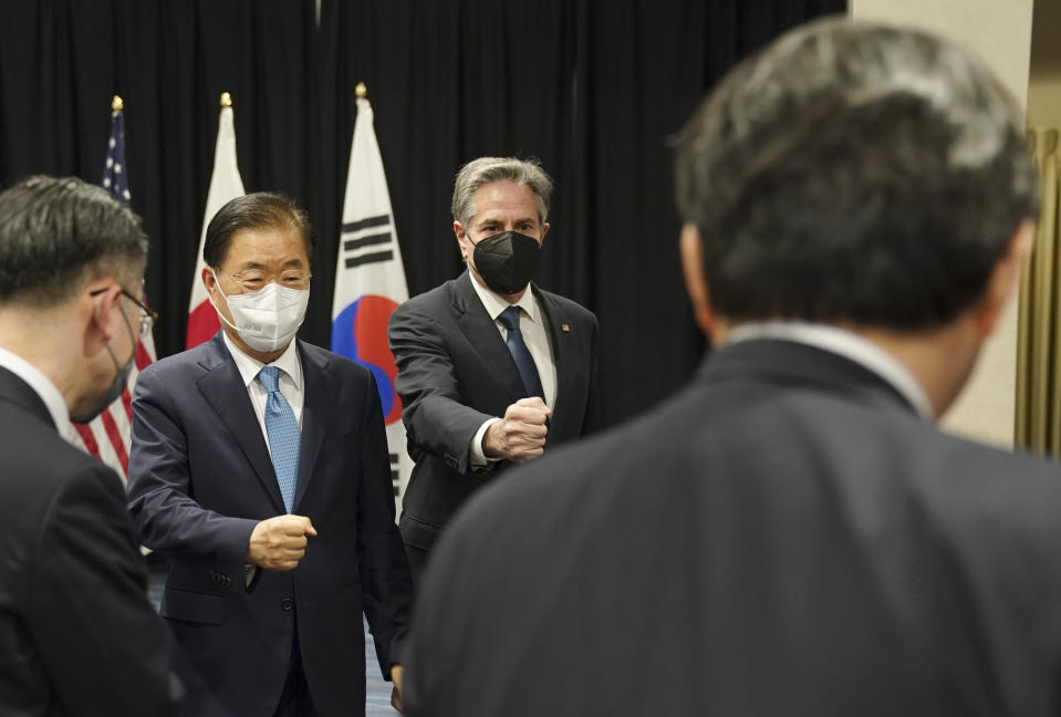 U.S. Secretary of State Antony Blinken and South Korean Foreign Minister Chung Eui-yong reach out for a fist bump with Japanese Foreign Minister Yoshimasa Hayashi at the end of a joint press availability following their meeting in Honolulu, Saturday, Feb. 12, 2022. (Kevin Lamarque/Pool Photo via AP)