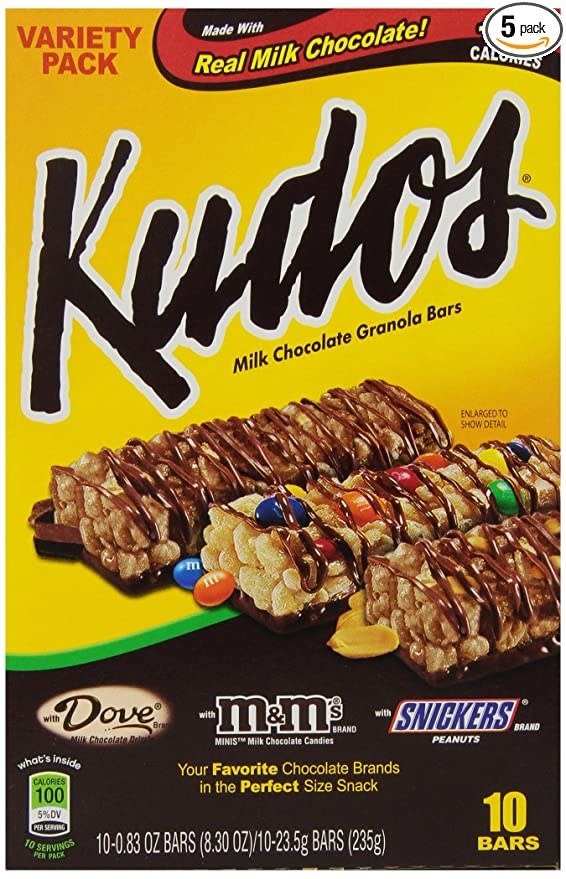 A front display of a box of Kudos in three flavors: Dove chocolate, M&M, and Snickers