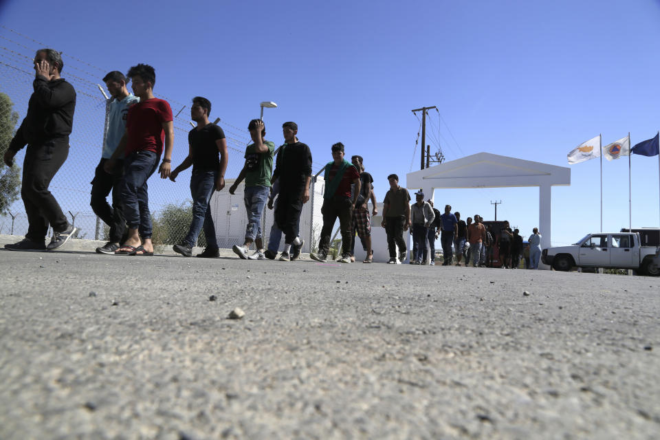 FILE - Migrants from Syria walk towards a refugee camp at Kokkinotrimithia, outside of the capital Nicosia, Sunday, Sept. 10, 2017, in the eastern Mediterranean island of Cyprus. The president of Cyprus Nikos Christodoulides said on Tuesday, April 2, 2024, he has personally asked the head of the European Union's executive arm to intercede with Lebanese authorities so that they could put a stop to boat loads of Syrian refugees from heading to the east Mediterranean island nation. (AP Photo/Petros Karadjias, File)