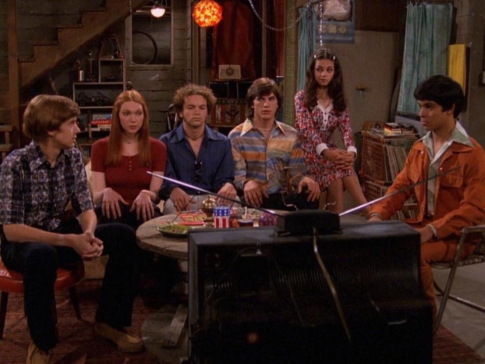 From left: Topher Grace, Laura Prepon, Danny Masterson, Ashton Kutcher, Mila Kunis, and Wilmer Valderrama on "That '70s Show."