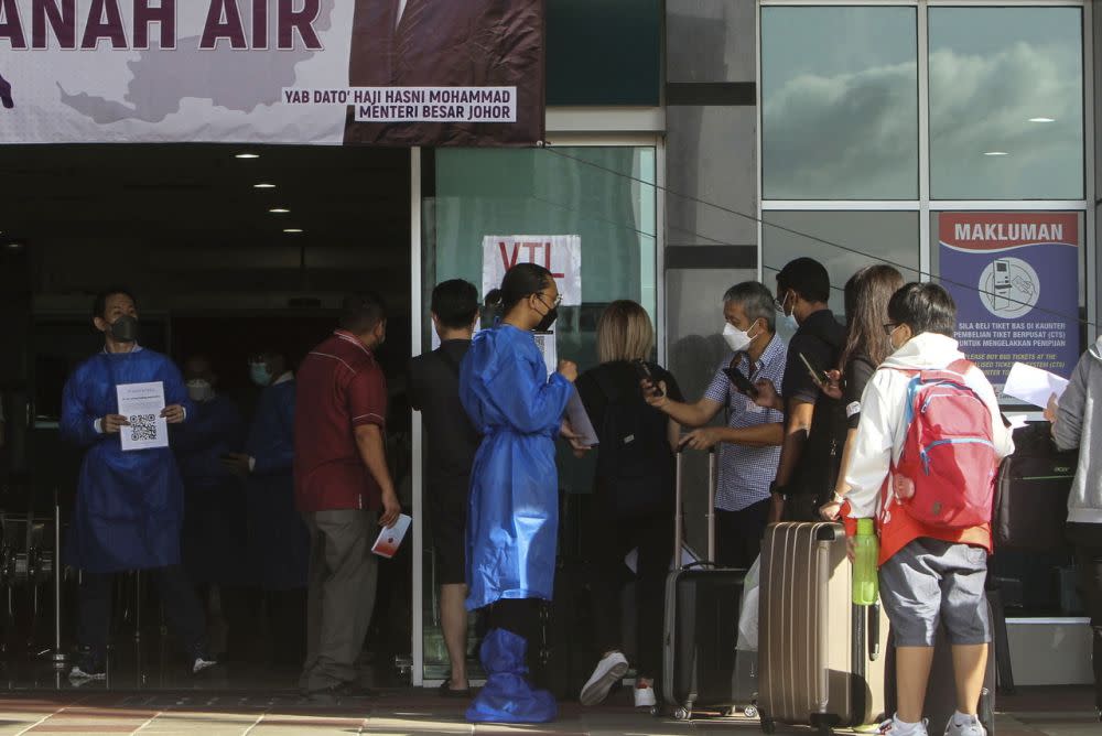 Travellers from Singapore arrive at the Larkin Sentral Bus Terminal in Johor Baru November 29, 2021. — Bernama pic