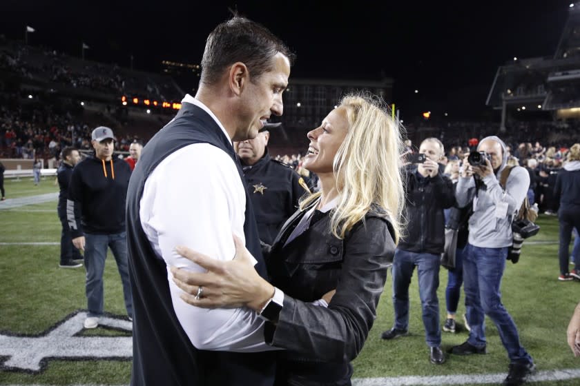 Cincinnati coach Luke Fickell celebrates with his wife, Amy, after a game against UCF at Nippert Stadium on Oct. 4, 2019