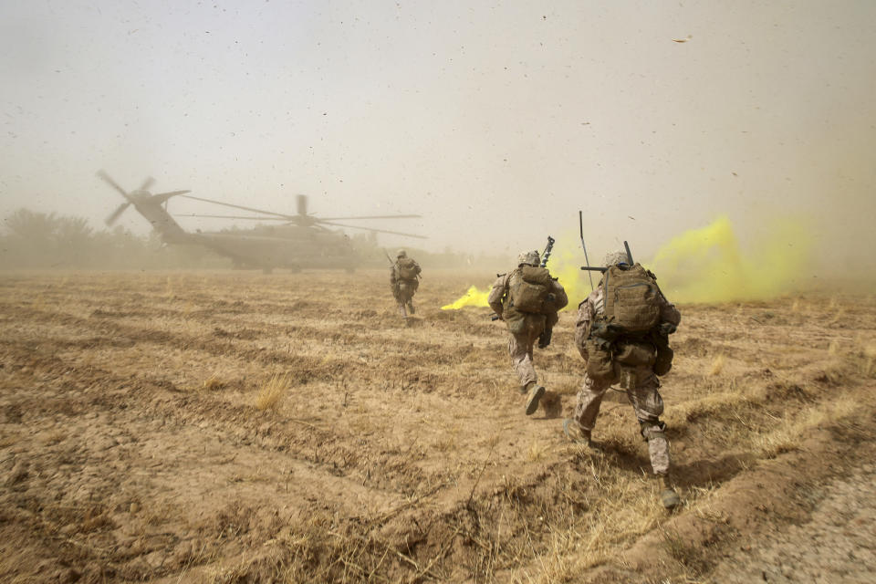 July 4, 2014 - U.S. Marines sprint across a field to load onto a CH-53E Super Stallion helicopter during a mission in Helmand province, Afghanistan.