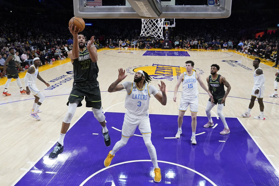 Minnesota Timberwolves center Rudy Gobert (27) shoots next to Los Angeles Lakers forward Anthony Davis (3) during the first half of an NBA basketball game Friday, March 3, 2023, in Los Angeles. (AP Photo/Marcio Jose Sanchez)