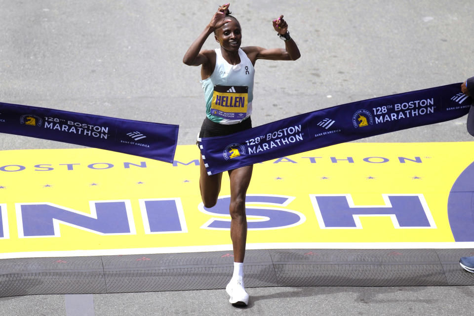La keniata Hellen Obiri levanta los brazos tras ganar la categoría femenina del Maratón de Boston el lunes 15 de abril del 2024. (AP Foto/Charles Krupa)