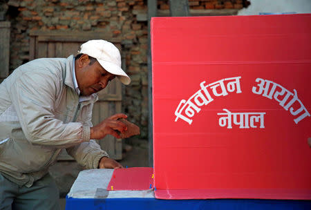 An election officer sets up a booth at a polling station a day ahead of the parliamentary and provincial elections in Kathmandu, Nepal December 6, 2017. REUTERS/Navesh Chitrakar