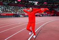 <p>Liu Shiying of Team China celebrates with the national flag after winning gold in the Women's Javelin Final. </p>