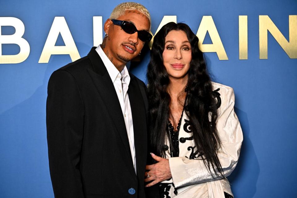 A celebrity couple poses during a Fashion Week event