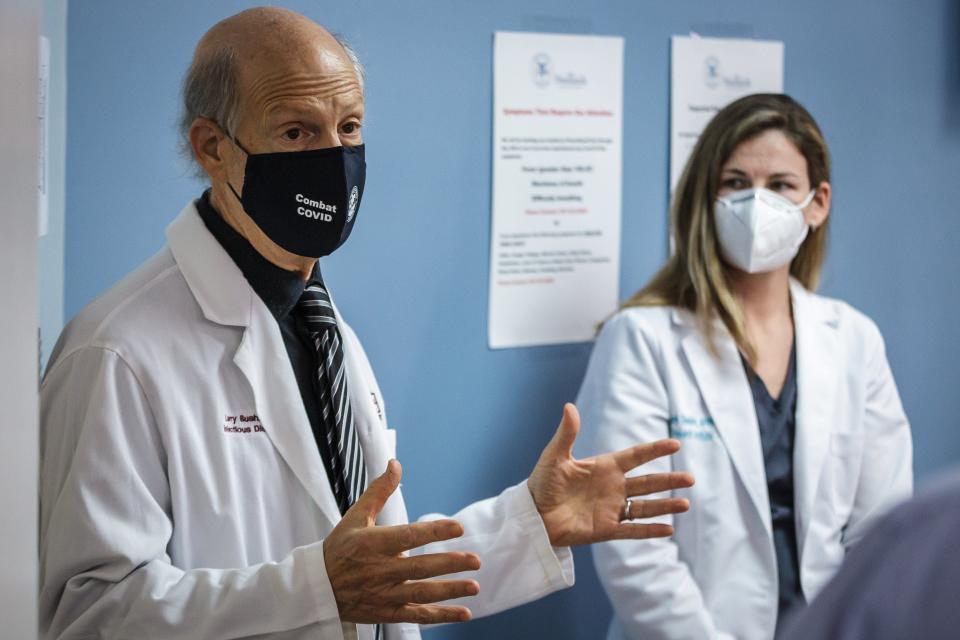 An AstraZeneca COVID-19 vaccine trial is set to start this week on the campus of JFK Medical Center in Atlantis, Fla. Dr. Larry Bush and nurse practitioner Elizabeth Sheldon talk to the press on Monday, August 17, 2020. [THOMAS CORDY/palmbeachpost.com]