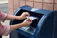 An individual mails letters through the U.S. Postal Service (USPS) in Philadelphia