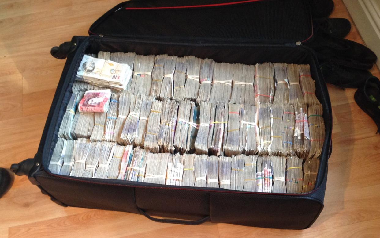 A suitcase with over £500,000 was found during a search of a property in the Thatto Heath area of St Helens - PA