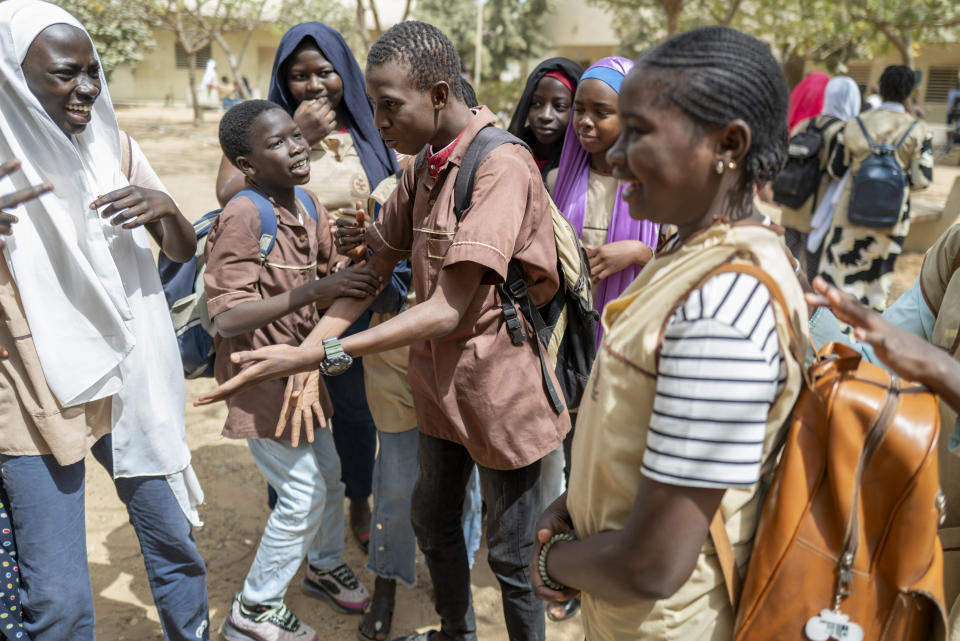 Mouhamed Sall, who is deaf, communicates using sign language at the Guinaw Rail Sud public high school in Pikine, Senegal, Monday, March 18, 2024. Sall and three other students are part of a new approach in a small number of schools in Senegal that seat those who are deaf and hard of hearing with the rest of the class. (AP Photo/Sylvain Cherkaoui)