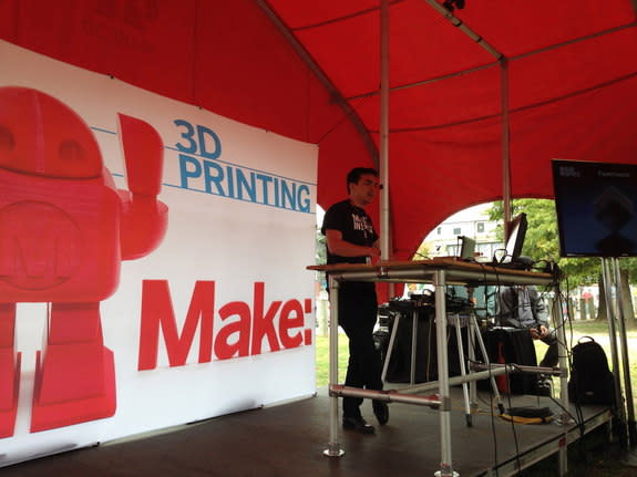 Made in Space co-founder and chief strategy officer Mike Chen discusses his company's 3D printer, which is launching to the International Space Station in 2014, with an audience at the 2013 World Maker Faire at the New York Hall of Science in N