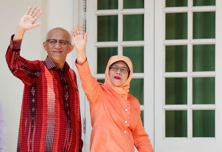 Former speaker of Singapore's parliament, Halimah Yacob, arrives with her husband Mohammed Abdullah Alhabshee to submit her presidential nomination papers at the nomination centre in Singapore September 13, 2017. REUTERS/Edgar Su