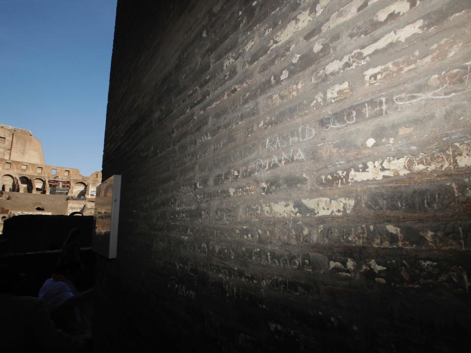 colosseum rome carved names tourism