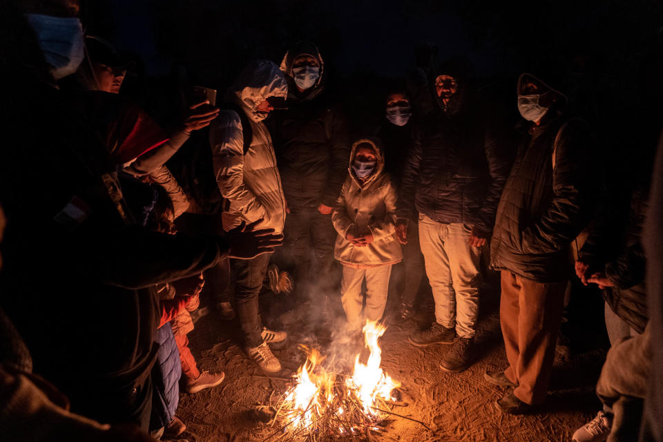 Migrants and asylum seekers are detained by U.S. Border Patrol agents after crossing the U.S.-Mexico border in Yuma County, near the Cocopah Indian Tribe's reservation on Dec. 8, 2022. Border Patrol agents estimated the group to be about 700 people.