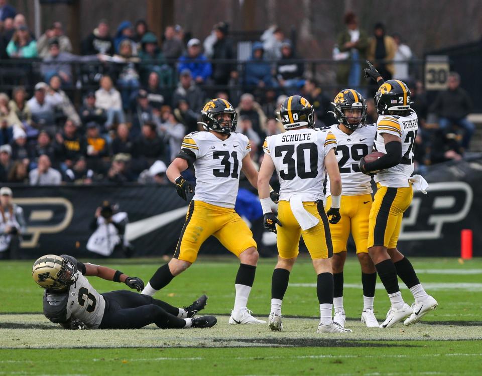 Iowa Hawkeyes defensive back Kaevon Merriweather (26) celebrates after intercepting a ball meant for Purdue Boilermakers wide receiver Tyrone Tracy Jr. (3) during the NCAA football game against the Purdue Boilermakers, Saturday, Nov. 5, 2022, at Ross-Ade Stadium in West Lafayette, Ind.