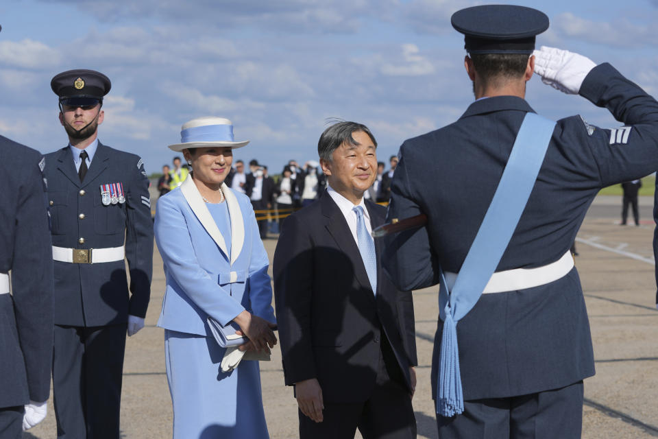 Emperor Naruhito is saluted by a member of the honour guard as he and Empress Masako arrive at Stansted Airport, England, Saturday, June 22, 2024, ahead of a state visit. The state visit begins Tuesday, when King Charles III and Queen Camilla will formally welcome the Emperor and Empress before taking a ceremonial carriage ride to Buckingham Palace. (AP Photo/Kin Cheung)