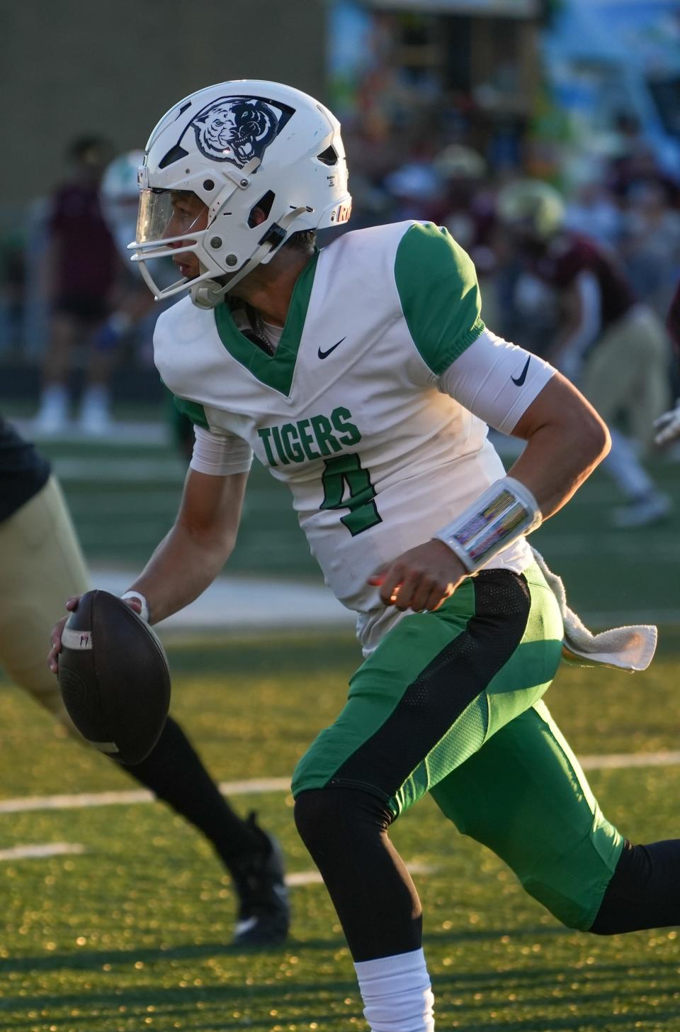 Triton Central Tigers Jace Stuckey (4) looks for an opening during the game between the Lutheran Saints and the Triton Central Tigers on Friday, Sept. 1, 2023, at Lutheran High School in Indianapolis. Lutheran Saints defeated Triton Central Tigers 43-13.