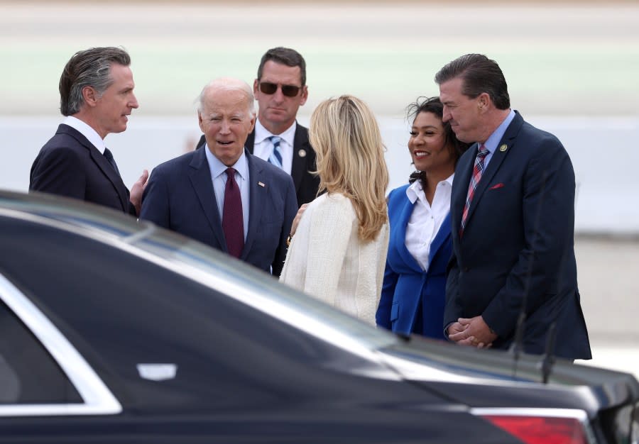 U.S. President Joe Biden (C) talks with California Governor Gavin Newson (L) and his wife Jennifer Siebel Newsom (R) after arriving at San Francisco International Airport November 14, 2023. (Photo by Justin Sullivan/Getty Images)