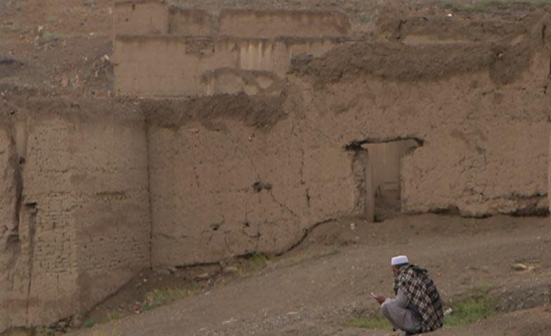 Marshal, the only remaining resident of   Daagbaghri, in Afghanistan's Wardak Province, sits among the ruins of his once-thriving village, August 2022. Daagbaghri became a ghost town when it was caught on the front line in the war between the Taliban and U.S. forces a decade earlier. / Credit: CBS News