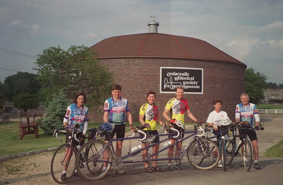 Riders stand in front of the Ice House Museum in Coralville.