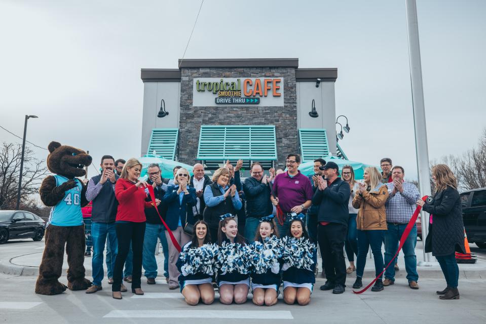 Bartlesville Chamber of Commerce members, Bartlesville High School Cheer Team, and Bruin Mascot gather to cut the ribbon for Friday's Tropical Smoothie Cafe grand opening.