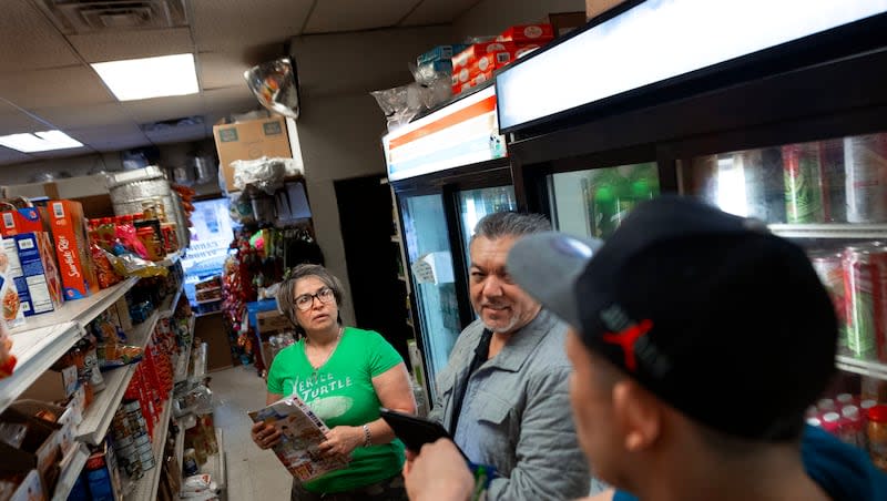 Juana Barajas, owner of La Tienda Mexicana, Tony Lomeli of La Bodega Wholesale and Janier Efrain Montenegro Flores discuss what merchandise needs to be ordered in Whitewater, Wis., on Monday, April 1, 2024. Barajas has owned the store on the Main Street of town for almost 24 years.