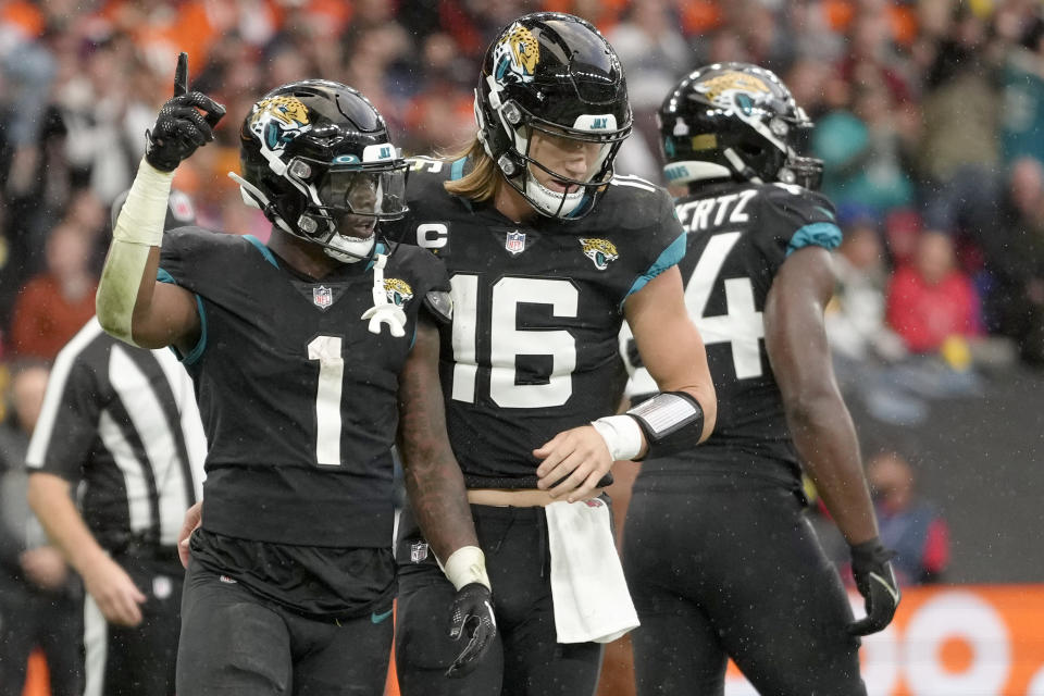 Jacksonville Jaguars running back Travis Etienne Jr. (1), and Jacksonville Jaguars quarterback Trevor Lawrence (16) celebrate after touchdown during the NFL football game between Denver Broncos and Jacksonville Jaguars at Wembley Stadium London, Sunday, Oct. 30, 2022. (AP Photo/Kirsty Wigglesworth)