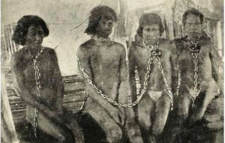 <span class="caption">Indigenous people in the Peruvian Amazon were enslaved by rubber barons into the 20th century.</span> <span class="attribution"><a class="link " href="https://en.wikipedia.org/wiki/Amazon_rubber_boom#/media/File:Hardenburgamazonindians.jpeg" rel="nofollow noopener" target="_blank" data-ylk="slk:Walter Hardenberg/Wikipedia;elm:context_link;itc:0;sec:content-canvas">Walter Hardenberg/Wikipedia</a></span>