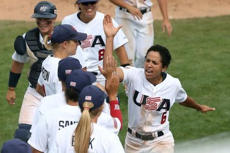 Jul 20, 2015; Toronto, Ontario, CAN; United States first baseman Malaika Underwood (6) celebrates with teammates after scoring the tying run of the game in the third inning against Venezuela during the 2015 Pan Am Games at Ajax Pan Am Ballpark. Mandatory Credit: Tom Szczerbowski-USA TODAY Sports