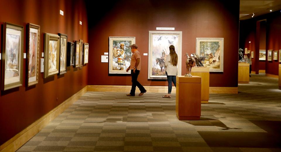 People look at the Prix de West Invitational Art Exhibition at the National Cowboy & Western Heritage Museum in Oklahoma City, Saturday, Aug. 8, 2020.