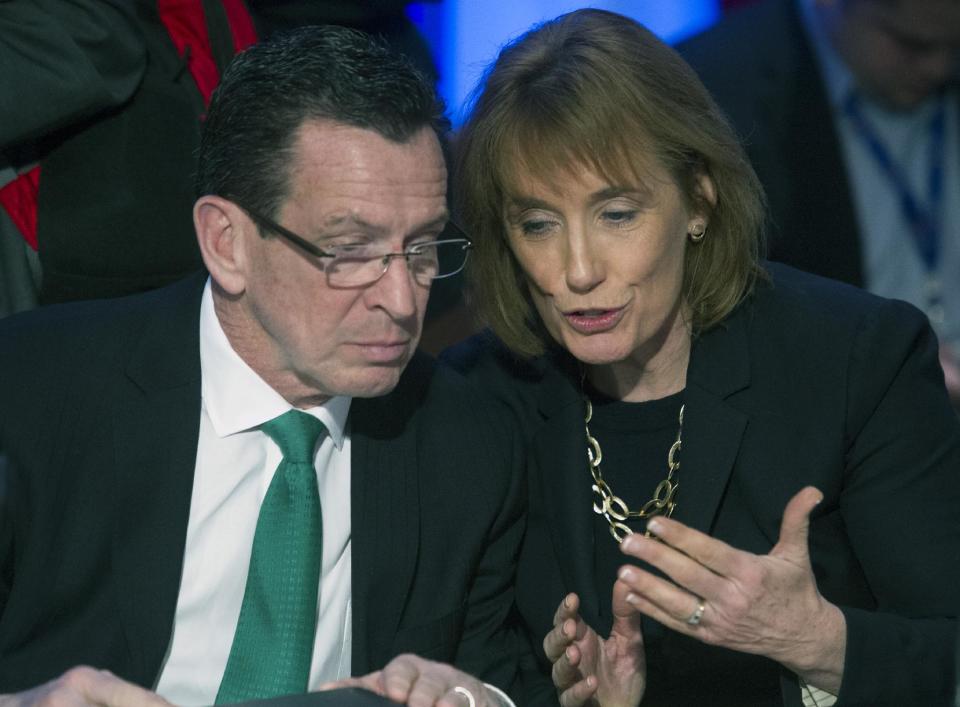 Connecticut Gov. Dannel Malloy, left, talks with New Hampshire Gov. Maggie Hassan while they participate in a special session on jobs in America during the National Governor's Association Winter Meeting in Washington, Sunday, Feb. 23, 2014. (AP Photo/Cliff Owen)