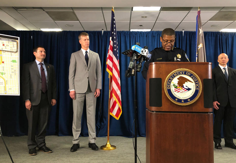 San Francisco Police Chief William Scott, speaking at the podium, joins Federal authorities announcing, Friday, March 13, 2020, indictments against 17 alleged members and associates of the MS-13 gang, saying they were trying to take over San Francisco's Mission neighborhood. Homeland Security Investigations special agent in charge Tatum King, left and second from left is U.S. Attorney for Northern California David Anderson. (AP Photo/Janie Har)