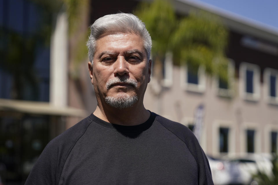 Ira Angustain, pastor at Kingdom Covenant Church, poses for a photo outside South Coast Health Center, where Dr. John Cheng worked, on Tuesday, May 17, 2022, in Aliso Viejo, Calif. Angustain said he was in contact with Cheng, 52, shortly before he was killed in Sunday's shooting at Geneva Presbyterian Church. (AP Photo/Ashley Landis)