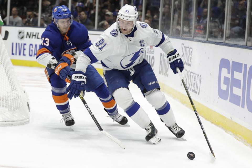New York Islanders' Mathew Barzal (13) defends against Tampa Bay Lightning's Steven Stamkos (91) during the first period of an NHL hockey game Friday, Nov. 1, 2019, in Uniondale, N.Y. (AP Photo/Frank Franklin II)