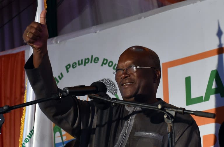 Roch Marc Christian Kabore waves to supporters at party headquarters in Ouagadougou on December 1, 2015 after winning Burkina Faso's presidential election