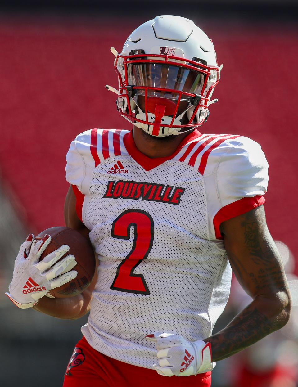 Dee Wiggins makes a catch and a run during practice at Cardinal Stadium on Sunday, April 3, 2021