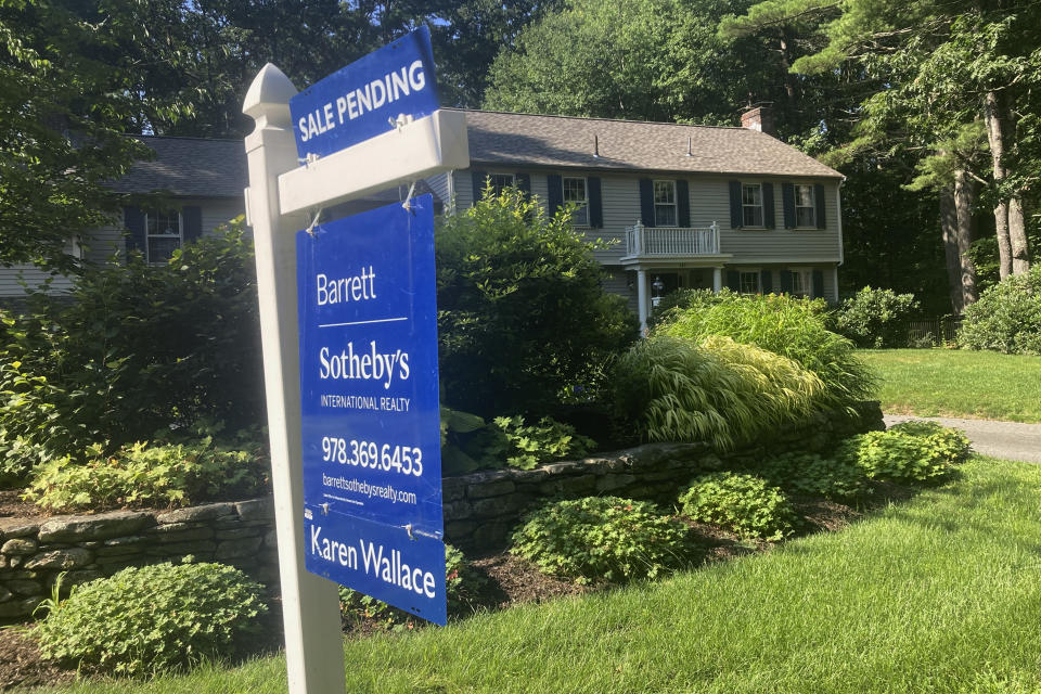 A sign noting a pending sale is shown in front of a home on Sunday, Aug. 20, 2023, in Concord, Mass. Sales of existing homes dropped 2.2% in July from the prior month. (AP Photo/Peter Morgan)