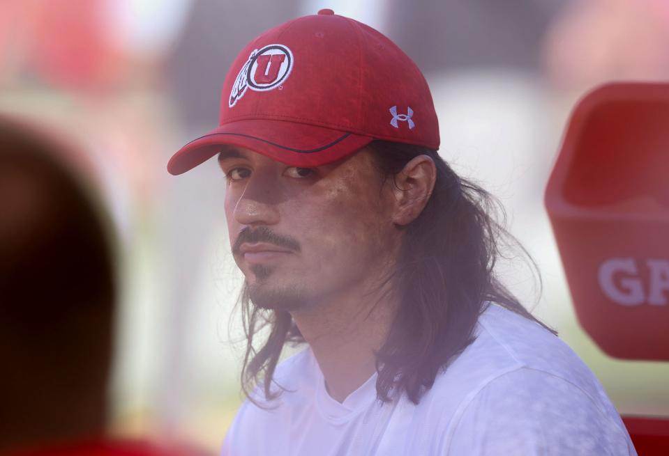 Utah QB Cam Rising watches from the sideline as Utah warms up for a game against the USC Trojans at the Los Angeles Memorial Coliseum on Saturday, Oct. 21, 2023.