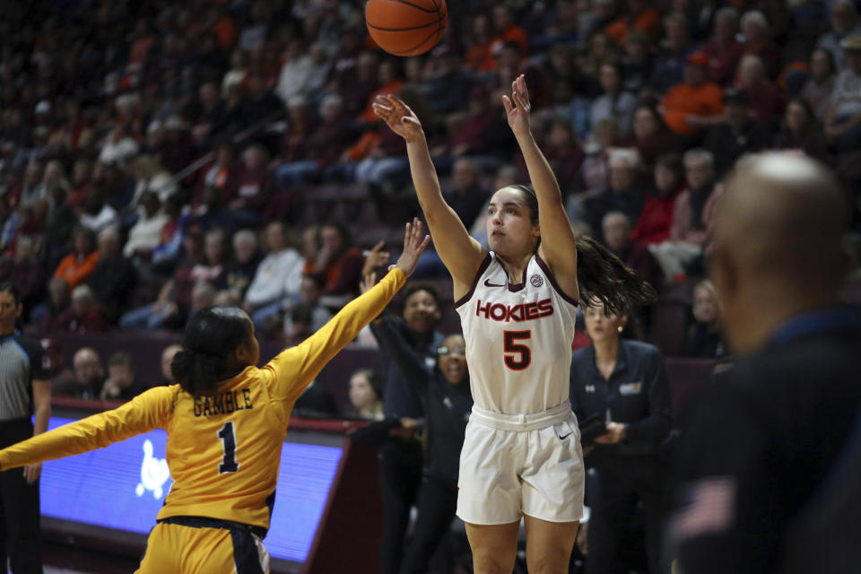 Virginia Tech's Georgia Amoore (5) shoots over UNC-Greensboro's Jayde Gamble (1) in the first half of an NCAA college basketball game in Blacksburg, Va., Monday, Nov. 20 2023. (Matt Gentry/The Roanoke Times via AP)