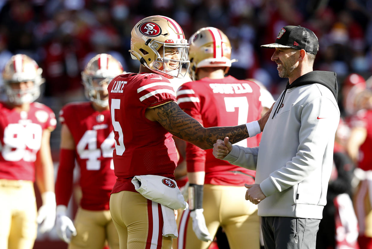 Trey Lance #5 of the San Francisco 49ers and Head Coach Kyle Shanahan 