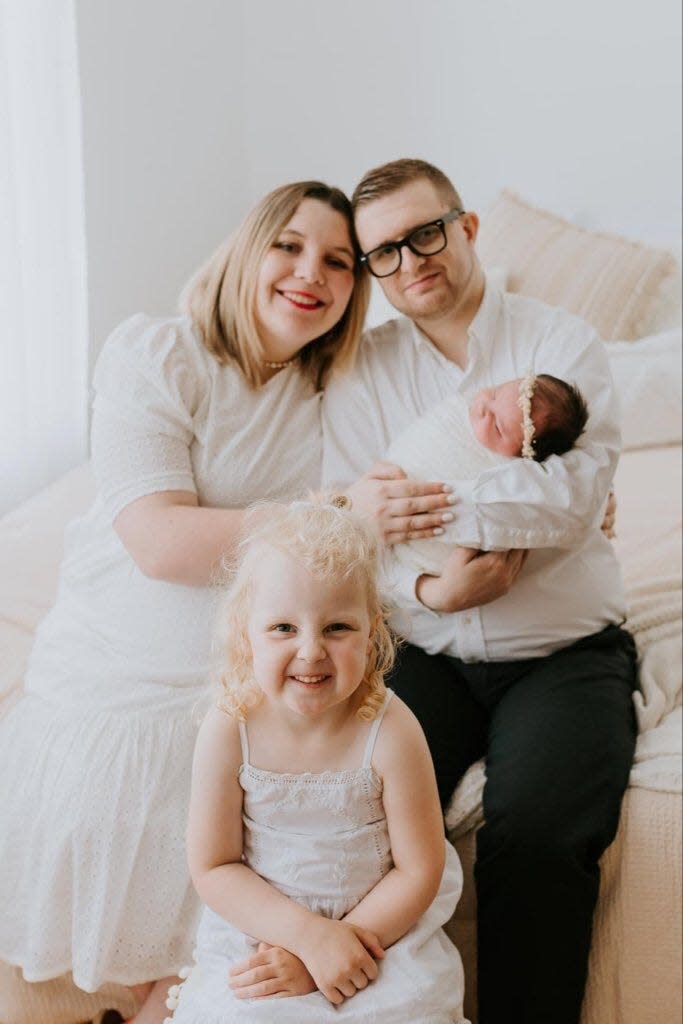 Priscilla and Anthony Wells pose with their daughters.