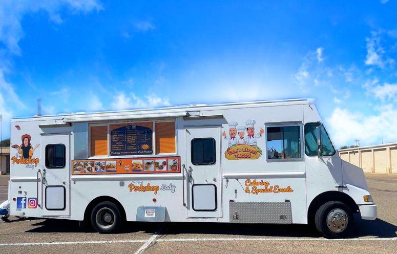 The Porkchop Lady/Sam's Street Tacos food truck sits in a parking lot on a sunny Pueblo day.
