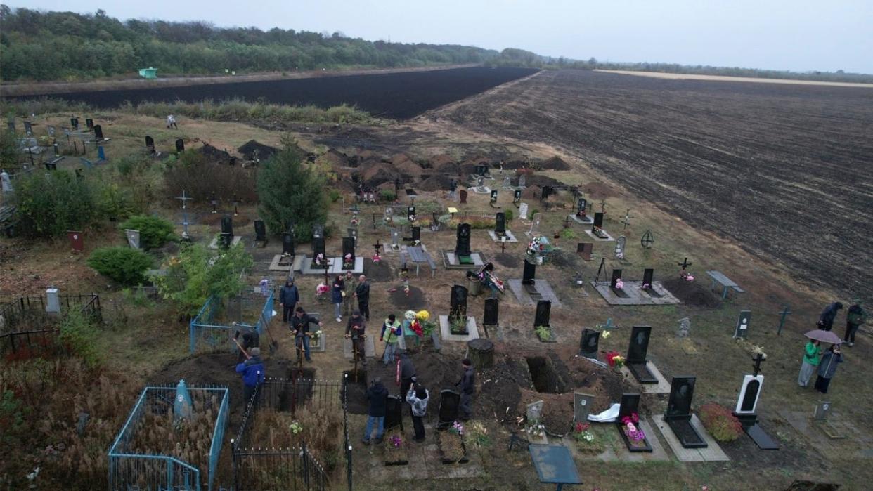 New graves for victims of the rocket strike are seen at a graveyard in the village of Hroza (Copyright 2023 The Associated Press. All rights reserved.)